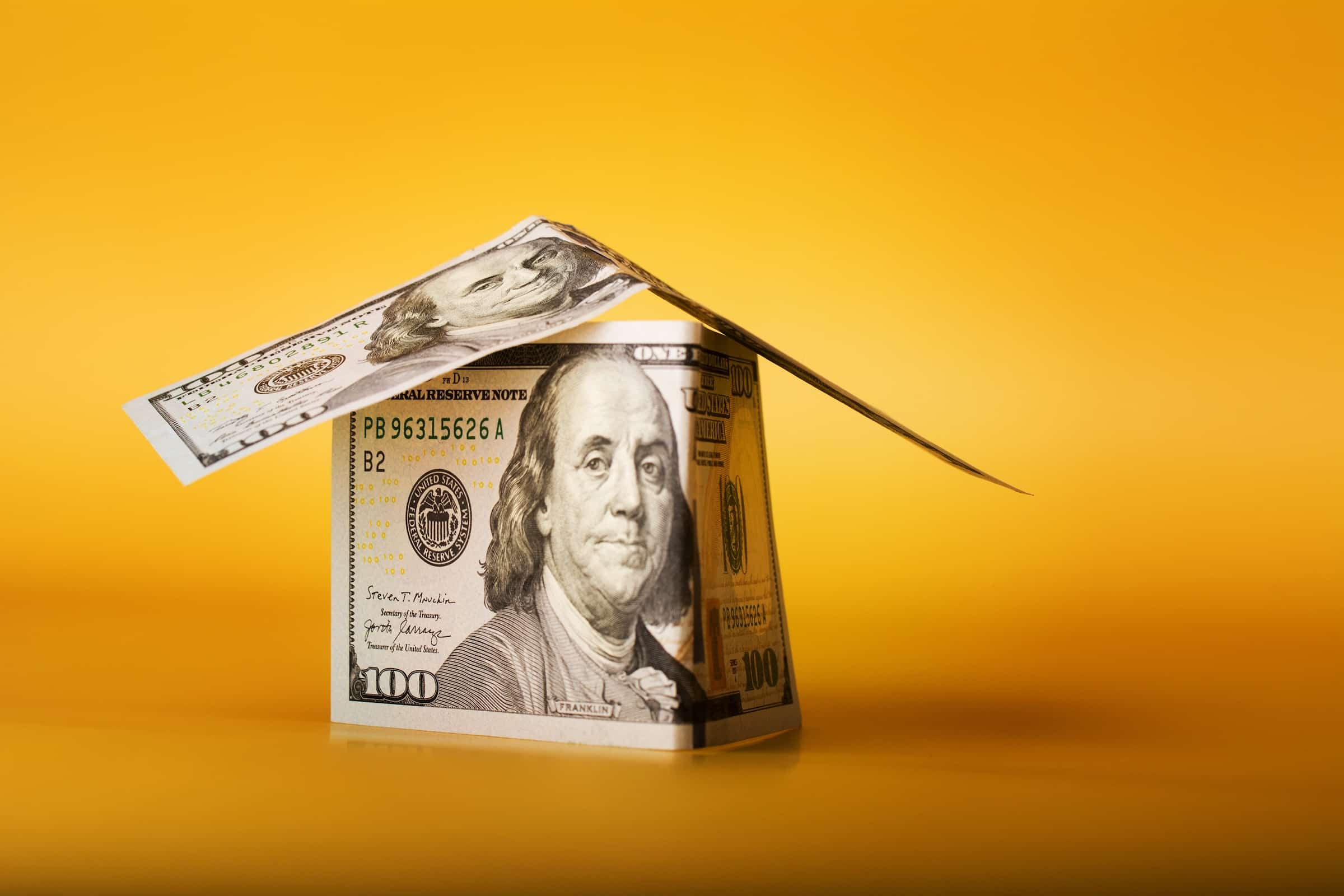 Hundred Dollar Bills Folded Into Shape Of House