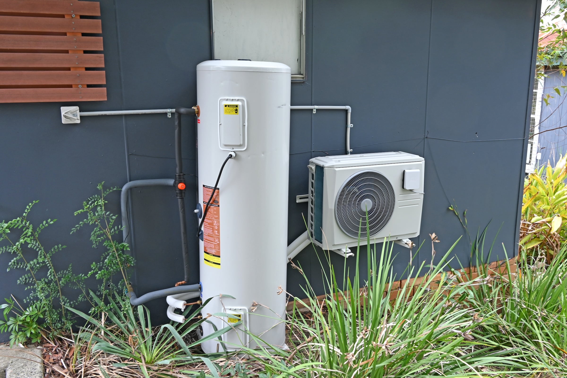 Heat Pump and Water Heater outside a house